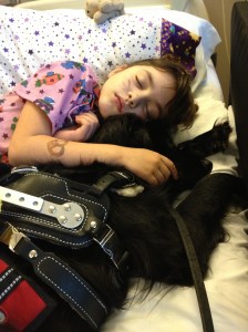 Haley and her service dog napping off a seizure during a hospitalization. 